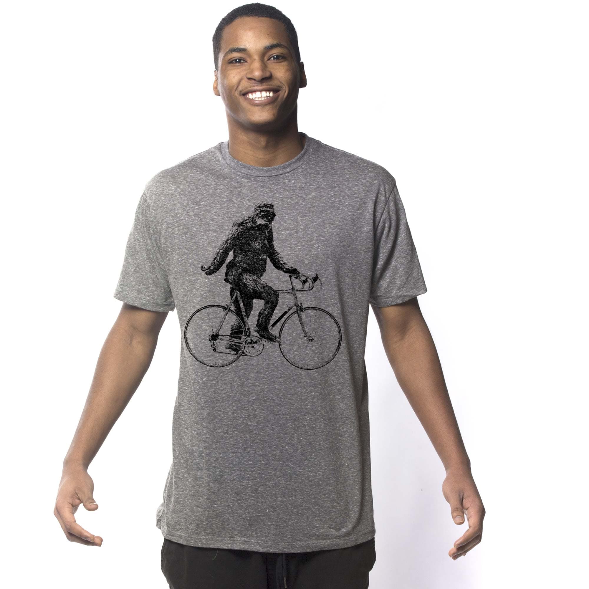 Men's Sasquatch Cyclist Funny Graphic T-Shirt | Vintage Bigfoot Bicycle Tee On Model | Solid Threads